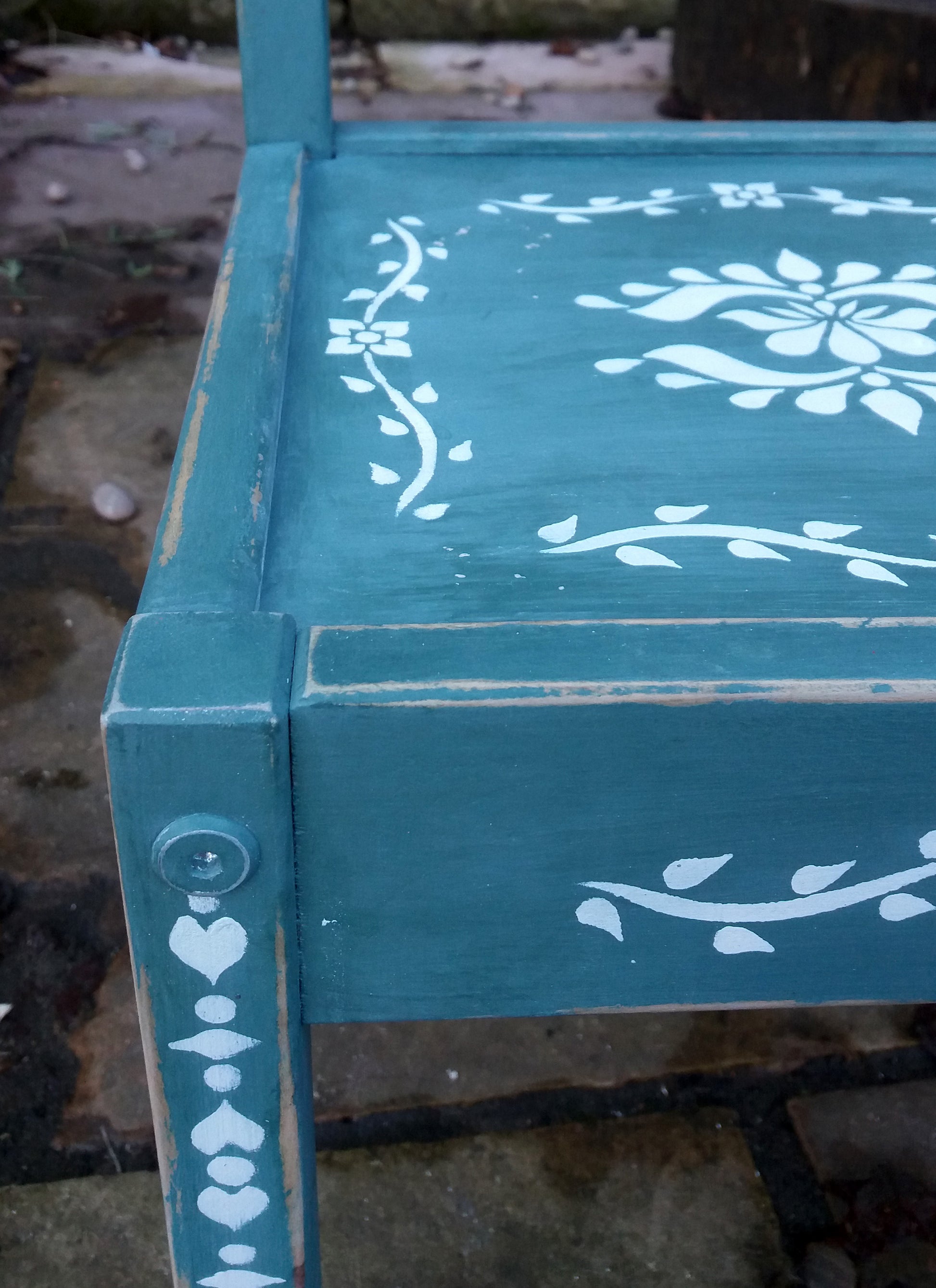 Little Children's chair painted in a deep green with folk art stencil design in white