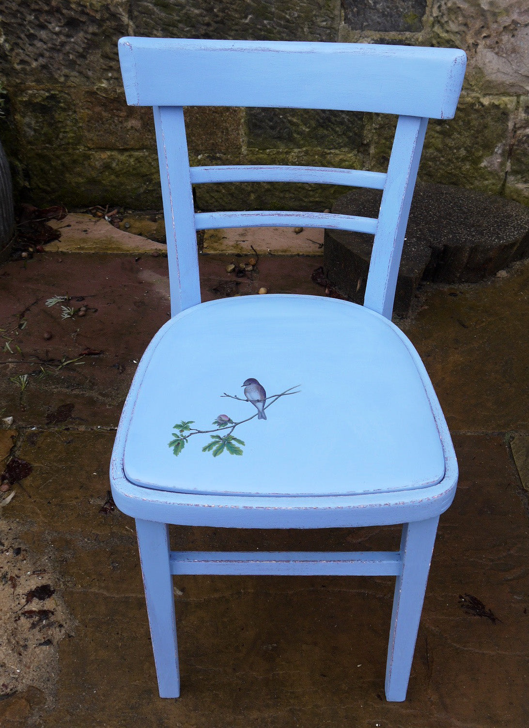 Little painted chair with painted vinyl seat and bird design. The woodwork has been painted in layers of aubergine and bright blue andxa bird on a branch has been added to the old vinyl seat.
