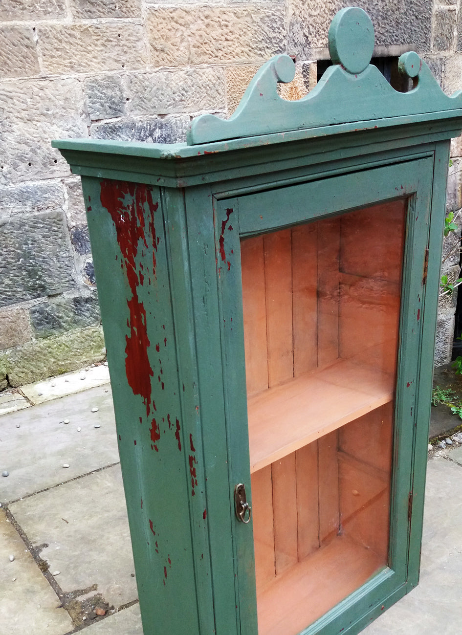 Vintage glass fronted cabinet in an antique chippy milk paint finish