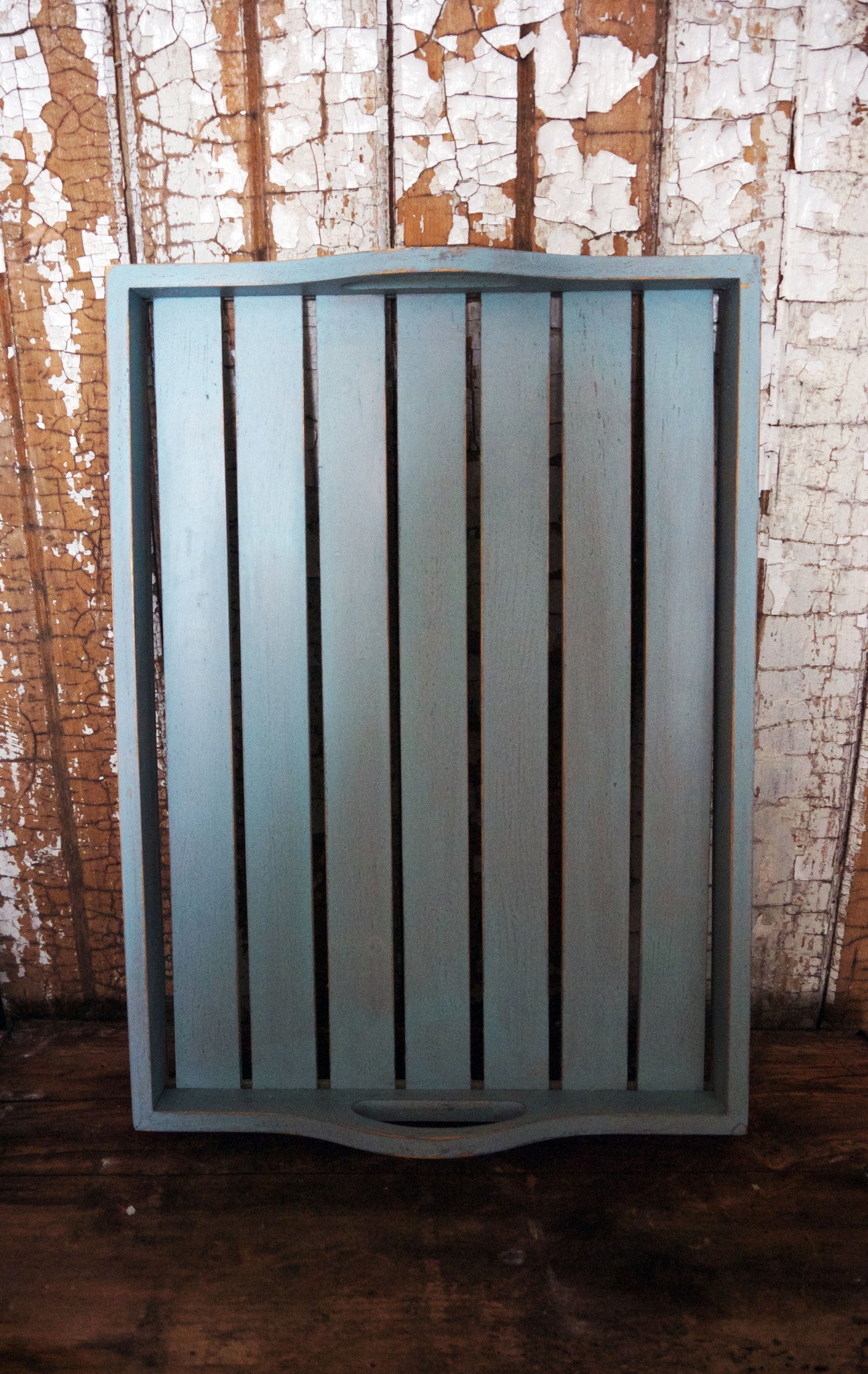 Vintage wooden slatted tray painted in layers of soft grey and blue