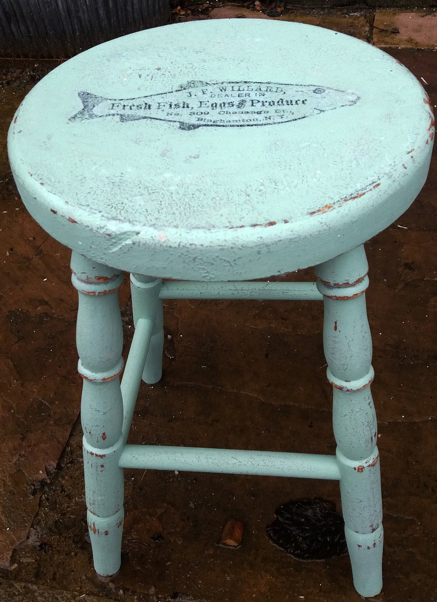 Vintage wooden stool painted in layers of textured paint with fish motif