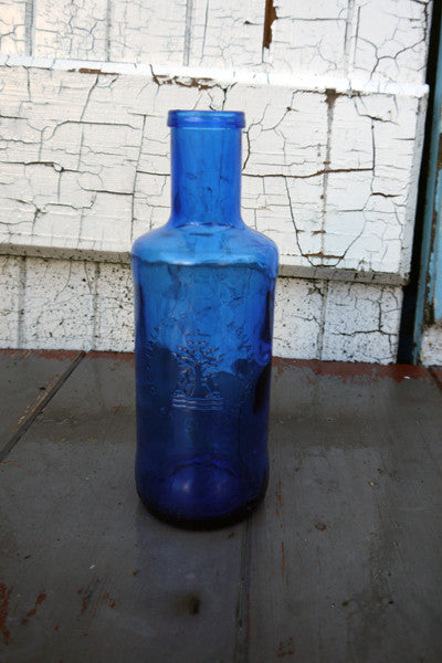 Lovely blue glass bottle bud vase, table water bottle or for the bathroom beautiful deep blue glass in great condition