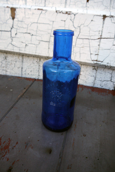 Lovely blue glass bottle bud vase, table water bottle or for the bathroom beautiful deep blue glass in great condition