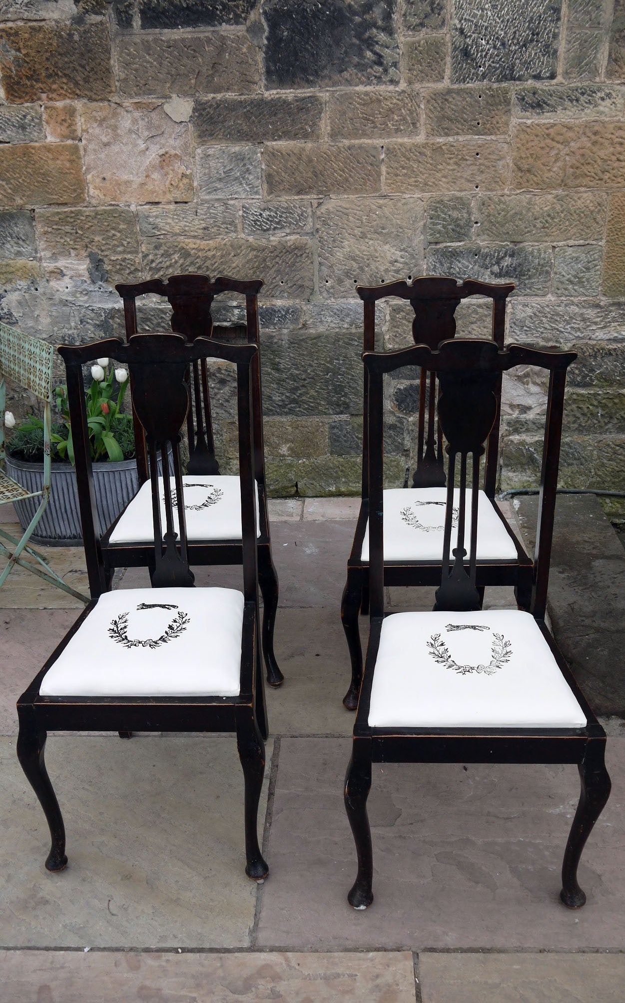 Set of four wooden vintage dining chairs with updated seat pads with a fox and wreath design.