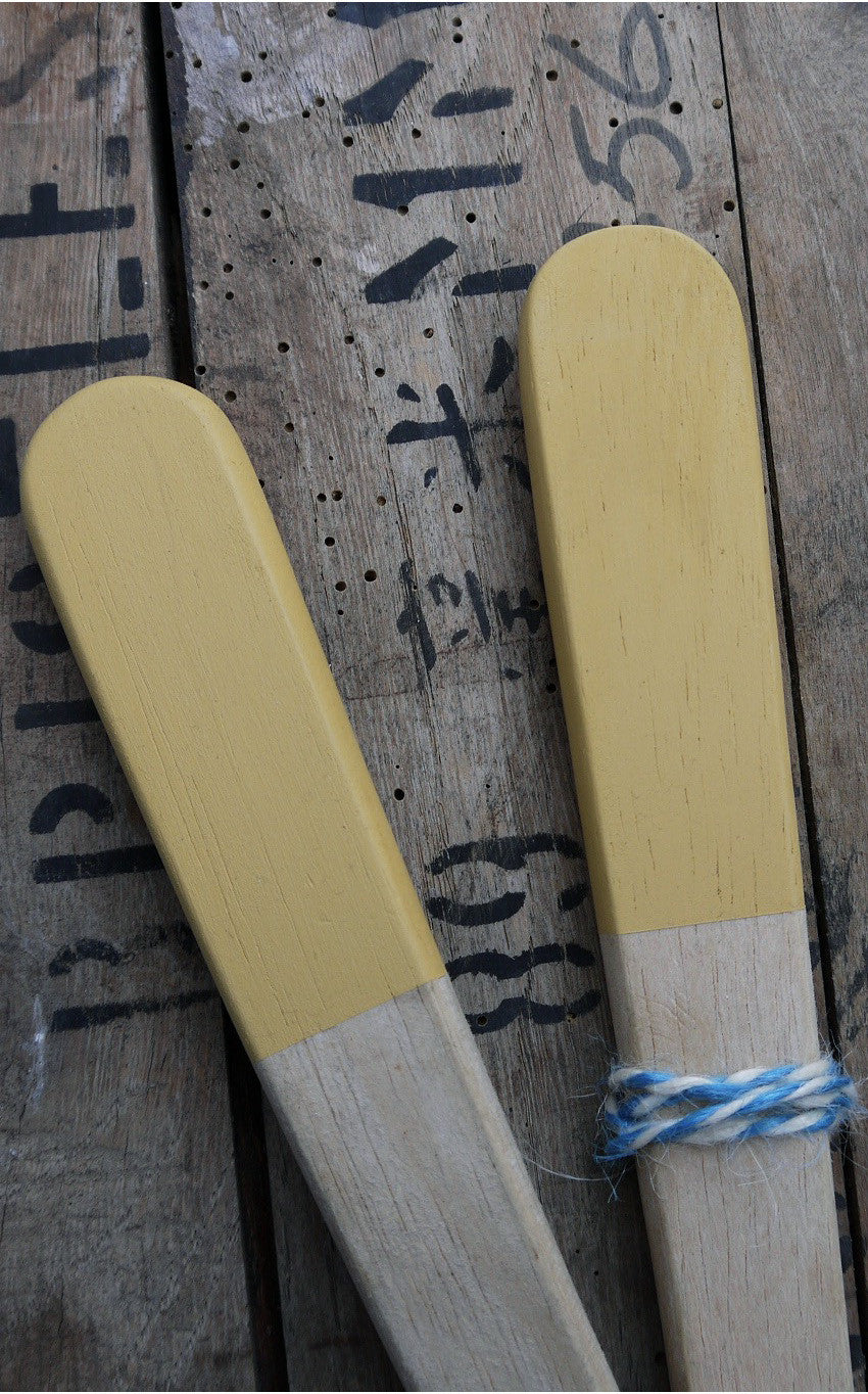 Set of vintage wooden salad servers with yellow handles.